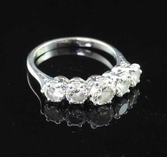 An 18ct white gold and graduated five stone diamond ring, size R.